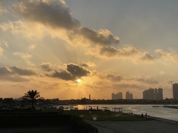 Scenic view of buildings against sky during sunset