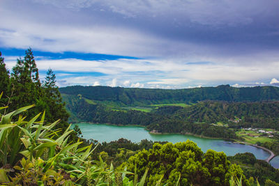 Scenic view of green landscape against sky