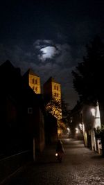 Illuminated cityscape against sky at night