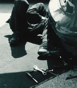 Low section of man sitting on road