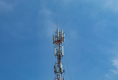 Low angle view of communications tower against blue sky