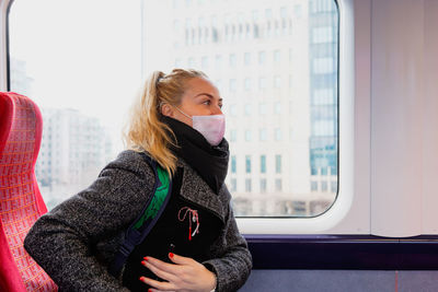 Beautiful young woman sitting in train