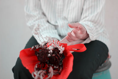 Close-up of hand holding red chili peppers