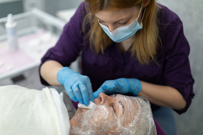 Midsection of doctor examining patient