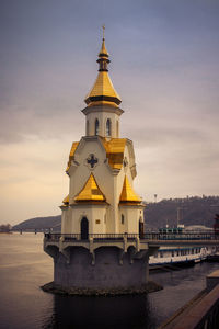 View of building by sea against sky during sunset. church of st. nicholas  kiev, ukraine