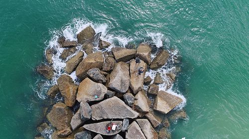 High angle view of rock by sea