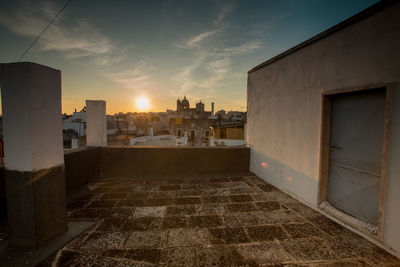 Buildings against sky during sunset