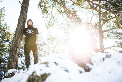 Portrait of woman standing on snow covered land