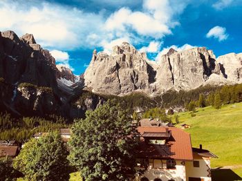 Panoramic view of trees and houses against sky