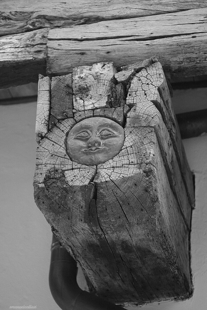 CLOSE-UP OF SCULPTURE ON WOODEN WALL