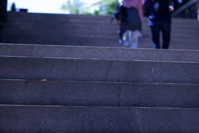 Low section of people walking on staircase