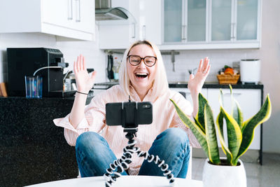 Laughing woman talking on video call at home