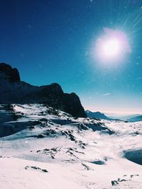 Scenic view of snowcapped mountains against clear sky at night