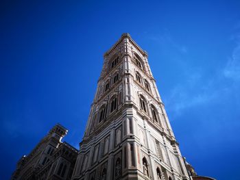 Low angle view of historic building against blue sky