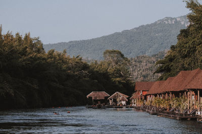 Scenic view of lake and buildings against sky