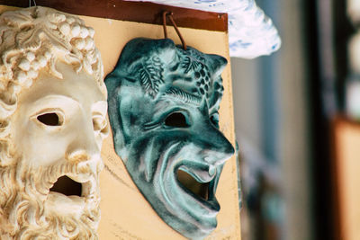 Close-up of mask handing on wall
