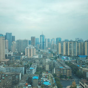 High angle view of modern buildings in city against sky