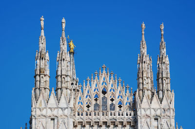 Low angle view of historical building against blue sky