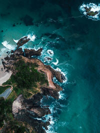 High angle view of rocks on sea shore