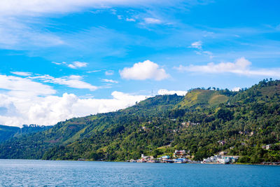 Scenic view of sea and mountains against sky