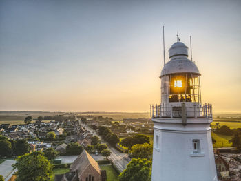 View of tower in city against sky during sunset