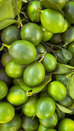 Full frame shot of green lemons at market