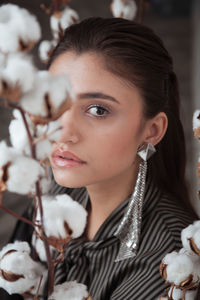 Close-up portrait of young woman with cotton