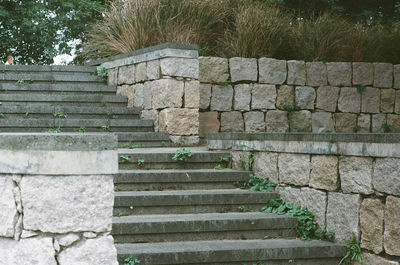 Staircase by stone wall
