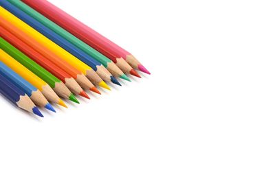 Close-up of multi colored pencils against white background