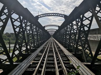 Low angle view of railway bridge against sky