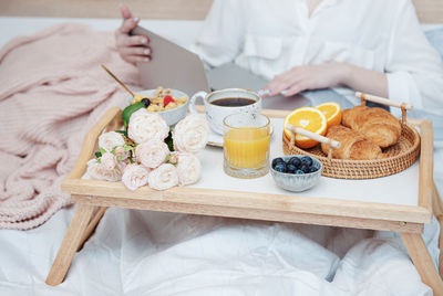 Romantic breakfast with coffee, waffles, orange juice and rose flowers.