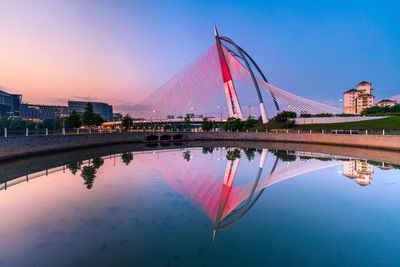 Reflection of building in lake at sunset