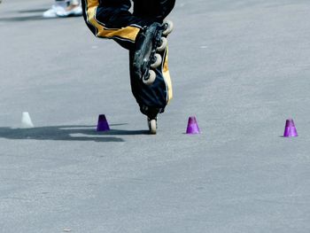 Low section of person skating on road