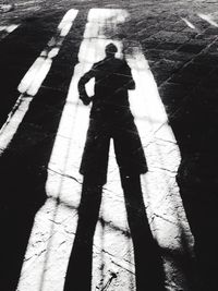 Shadow of man on road