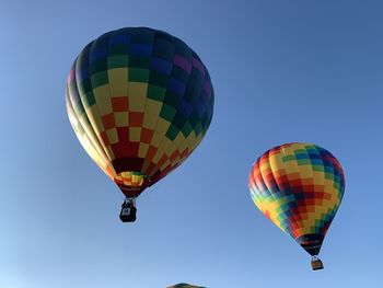 Low angle view of hot air balloon against clear blue sky