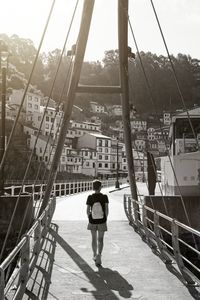 Rear view of woman standing on boat