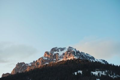 Low angle view of snowcapped mountain against sky