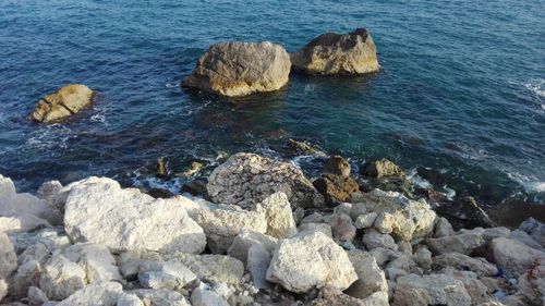 High angle view of rocks at sea shore