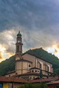 Low angle view of church against cloudy sky