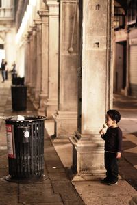 Rear view of man/child standing in abandoned building