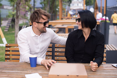 The couple ordered pizza. restaurant terrace