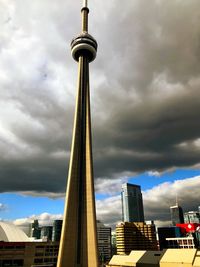 Low angle view of buildings against cloudy sky