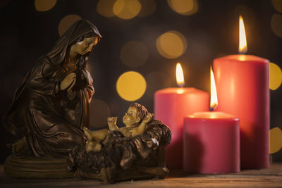 Close-up of illuminated candles on table during christmas