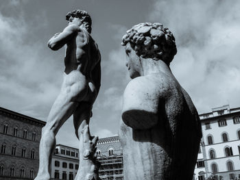 Low angle view of statue against sky in city