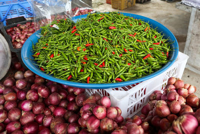 High angle view of chillis and onions in market