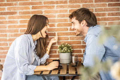 Female friends sitting on table