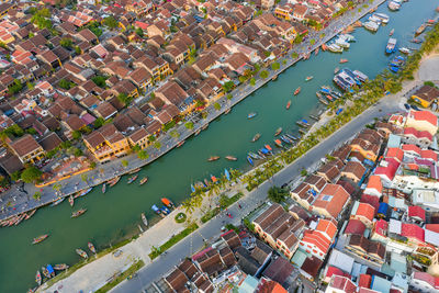 High angle view of buildings by river in city