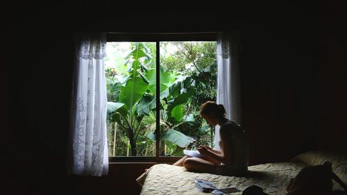 Man sitting in window at home