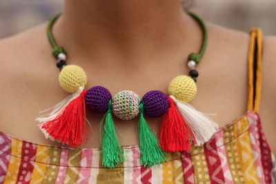 Close-up of woman with multi colored umbrellas