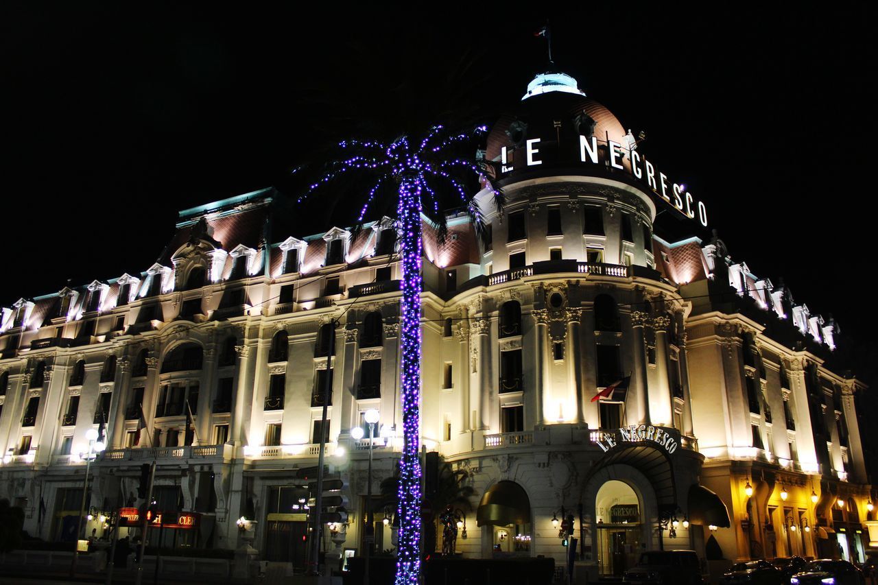 LOW ANGLE VIEW OF BUILDINGS AT NIGHT